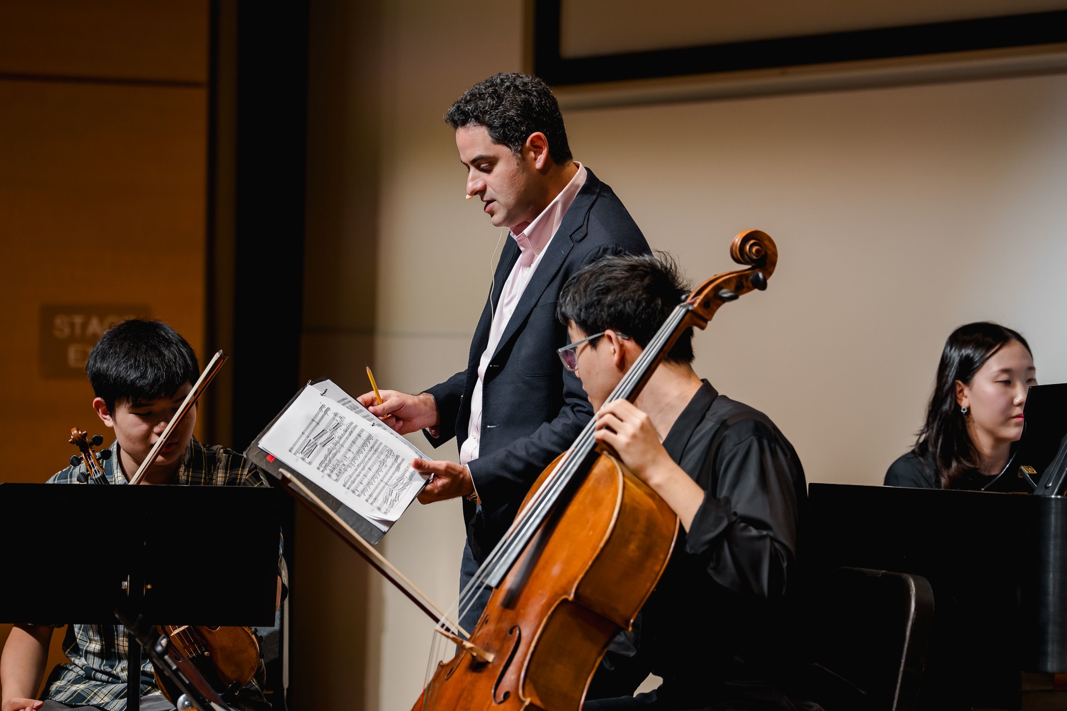 Arnaud Sussmann teaching a master class at Music@Menlo, July 23, 2025, coaching a piano trio of young musicians on stage.